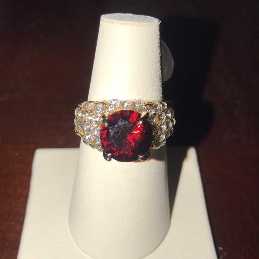Gold ring with red center stone